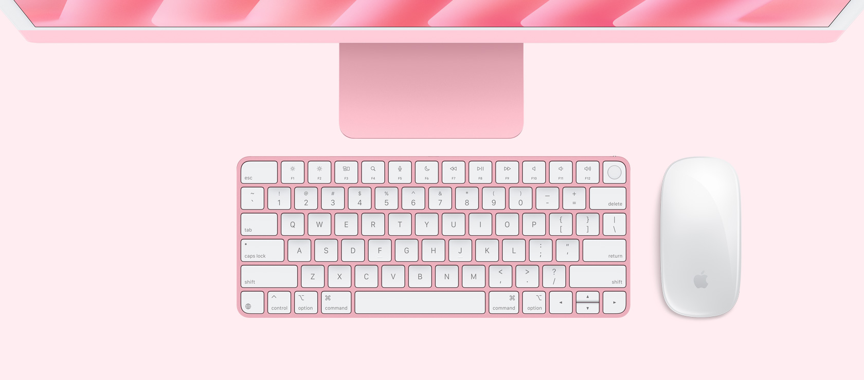 Изглед на розов iMac отгоре с мишка и клавиатура в съответстващ цвят